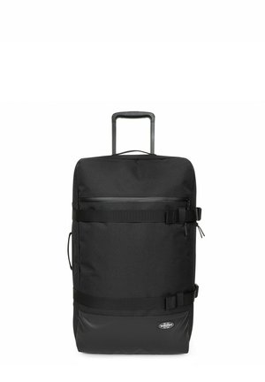 Sac de voyage noir avec une poignée rétractable, texture en tissu, poche avant zippée et bretelles ajustables pour une fermeture sécurisée.