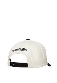 White cap with black accents, featuring embroidered "Mitchell & Ness" logo on the back, adjustable strap, and textured fabric.