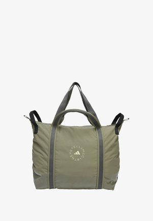 Grande borsa a tote verde oliva realizzata in materiale morbido e resistente. Presenta manici grigi, un logo circolare e un pannello lucido decorativo.