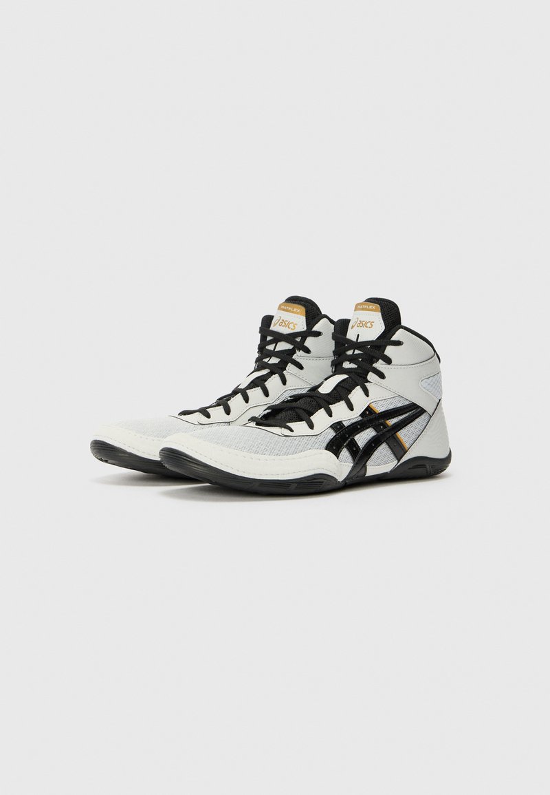 High-top athletic shoes in white, black, and gold. Features a textured upper, black laces, and a rubber sole with a sleek design.