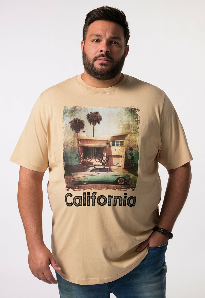 Béžové tričko s vintage grafikou palmy a autem a textem "California" tučně napsaným černými písmeny. Krátk�é rukávy, volný střih.