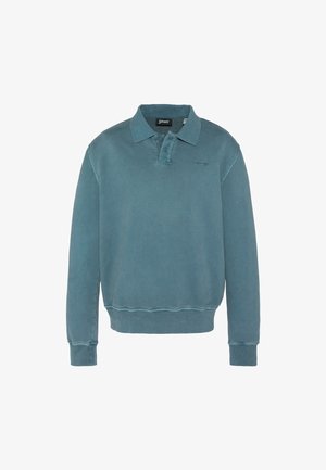 Bluza polo z długim rękawem w wyblakłym kolorze teal, z prążkowanymi mankietami, ściągaczem, plastronem z dwoma guzikami oraz małym haftowanym logo na lewej piersi.