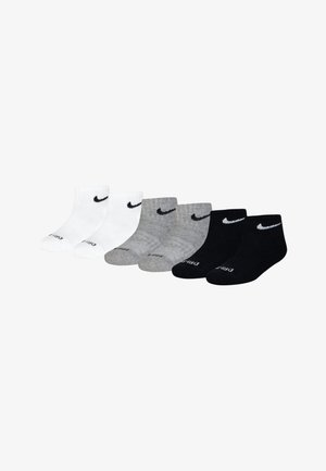 Nike ankle socks in white, gray, and black. Features ribbed texture, embroidered logo, and contrasting heel and toe accents.