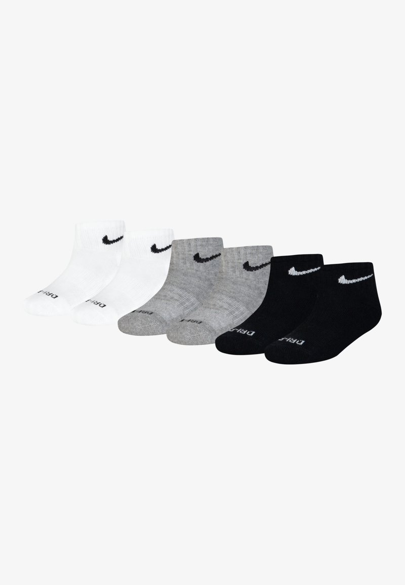 Calcetines de tobillo Nike en blanco, gris y negro. Presentan un diseño de textura acanalada, logo bordado y acentos contrastantes en el talón y la punta.