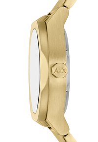 Złoty zegarek o szczotkowanym wykończeniu metalowym, elegancka ośmiokątna koperta oraz wyraźna heksagonalna korona z napisem "A/X."