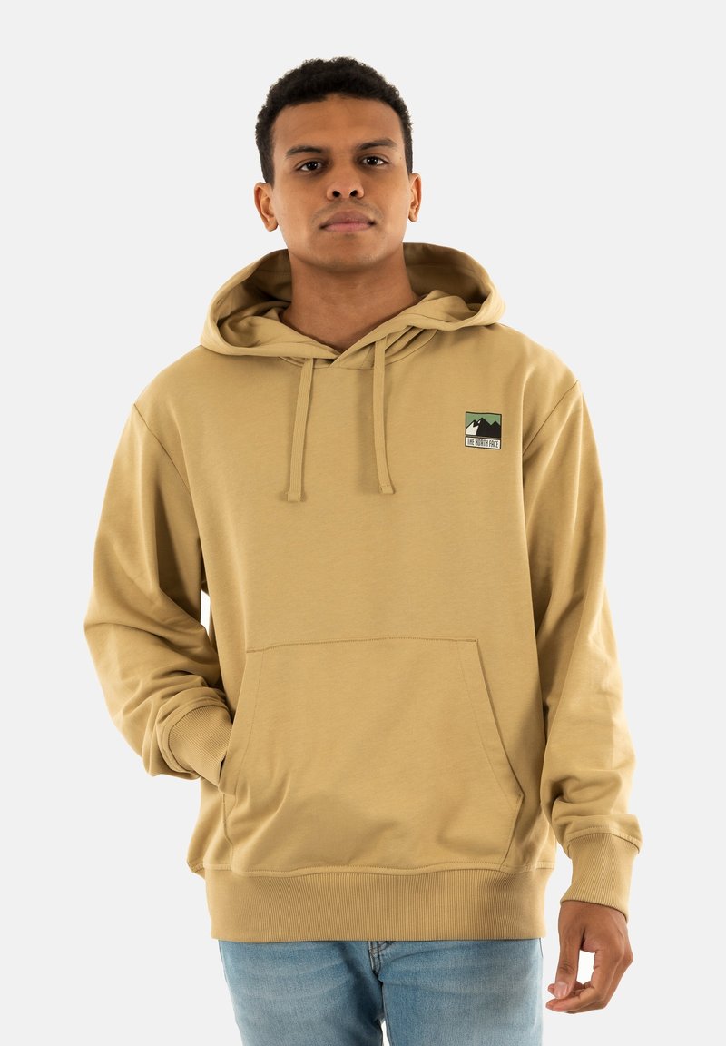 Sudadera beige hecha de una tela suave, con un bolsillo frontal, capucha con cordones y un pequeño parche de logo de outdoor en el lado izquierdo del pecho.
