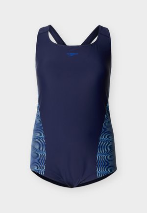 Tamsiai mėlynas vientisas Speedo maudymosi kostiumėlis su susikryžiavusiomis atgal užrišamomis petnešėlėmis ir šviesiai mėlynomis banguotomis juostelėmis šonuose.