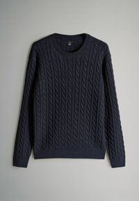 Mornarsko plavi pleteni pulover sa uzorkom pletenice, okruglim izrezom i dugim rukavima s rebrastim manžetama i donjim rubom. Napravljen od teksturirane tkanine.