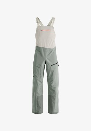 Green and gray bib overalls with adjustable straps, zippered pocket, and multiple front pockets. Made of durable fabric with soft texture.