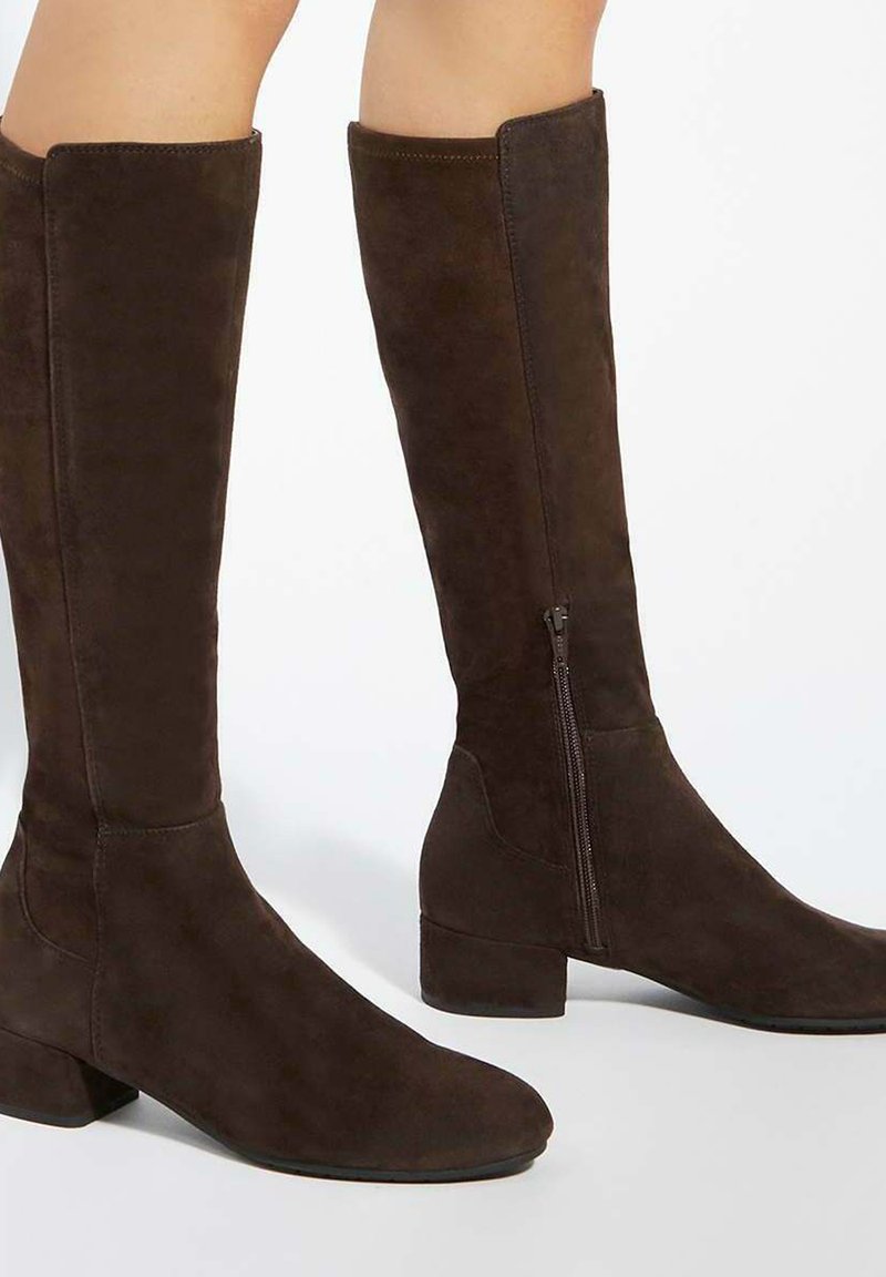 Brown suede knee-high boots with a low block heel and side zipper detail, featuring a smooth texture and clean lines.