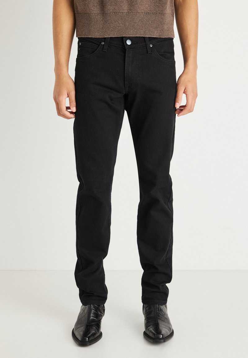 Pantalones vaqueros de mezclilla negra con corte recto. Presentan un clásico cierre con botón y cremallera, cinco bolsillos y detalles de costura sutil.