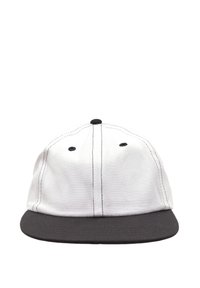 White fabric cap with a black flat brim. Features include black stitching and ventilation eyelets on the crown. No logos or patterns present.