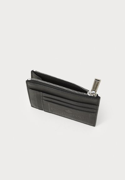 Black leather wallet with a zip closure, featuring card slots and a textured finish. Silver hardware accents enhance the design.