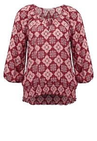 Blouse à motif rouge avec des manches longues, un col froncé et un ourlet smocké. Présente un design floral en diamant rose et blanc.