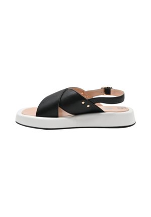 Sandal nera in pelle con cinturini incrociati, suola spessa bianca e cinturino con fibbia alla caviglia. Texture liscia con sottili accenti dorati.