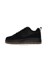Sneaker nera con tomaia in suede e suola in gomma, con un design testurizzato, punta rotonda e un passante sul tallone per una facile calzata.