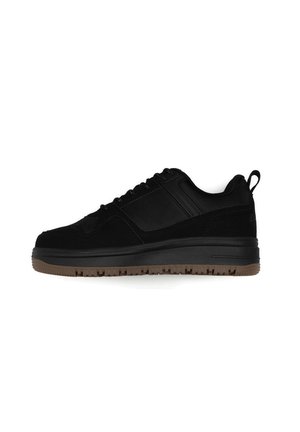 Sneaker nera con tomaia in suede e suola in gomma, con un design testurizzato, punta rotonda e un passante sul tallone per una facile calzata.
