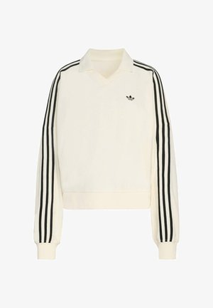 Kremasti pulover s V-izrezom, dugim rukavima, crnim prugama duž ruku i malim crnim logom na prsima. Izrađen od mekog materijala.