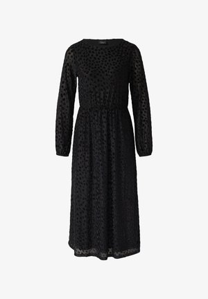 Schwarzes langärmeliges Kleid aus transparenter Stoffqualität, mit einem gerafften Tailleneinsatz und einem strukturierten Muster aus kleinen schwarzen Punkten.