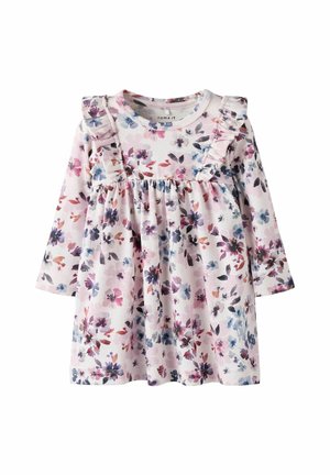 Robe à manches longues en fleurie de couleur rose clair avec des accents de manches froncées. Présente une taille froncée ornée d'un mélange vibrant de fleurs violettes et bleues.