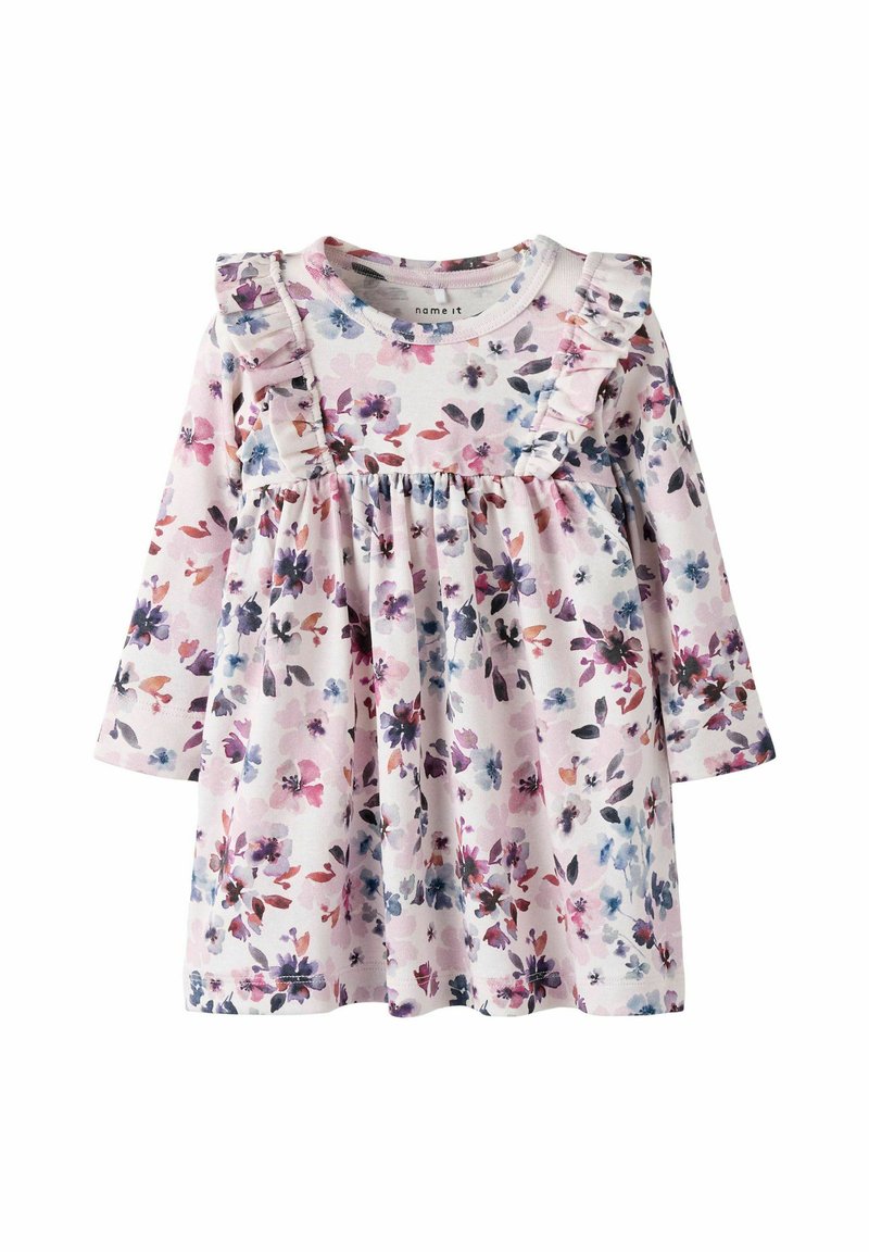 Robe à manches longues en fleurie de couleur rose clair avec des accents de manches froncées. Présente une taille froncée ornée d'un mélange vibrant de fleurs violettes et bleues.