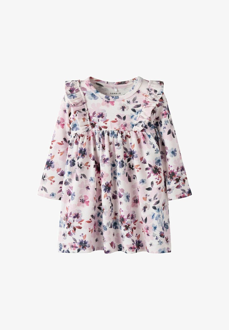 Robe à manches longues en fleurie de couleur rose clair avec des accents de manches froncées. Présente une taille froncée ornée d'un mélange vibrant de fleurs violettes et bleues.