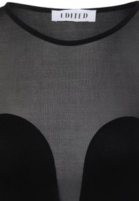 Black mesh top featuring a round neckline, semi-transparent fabric with a smooth texture, and oversized black cut-outs around the bust area.