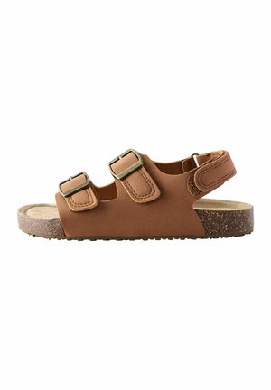 Braune Sandalen mit zwei verstellbaren Riemen, bronzefarbenen Schnallen und einer strukturierten Korkfußbett. Die Außensohle hat ein Grip-Design für bessere Rutschfestigkeit.