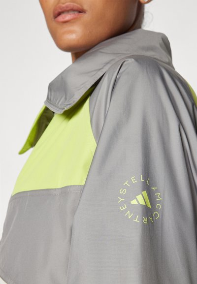 adidas by Stella McCartney Veste coupe-vent - bahia glow/dove grey/halo