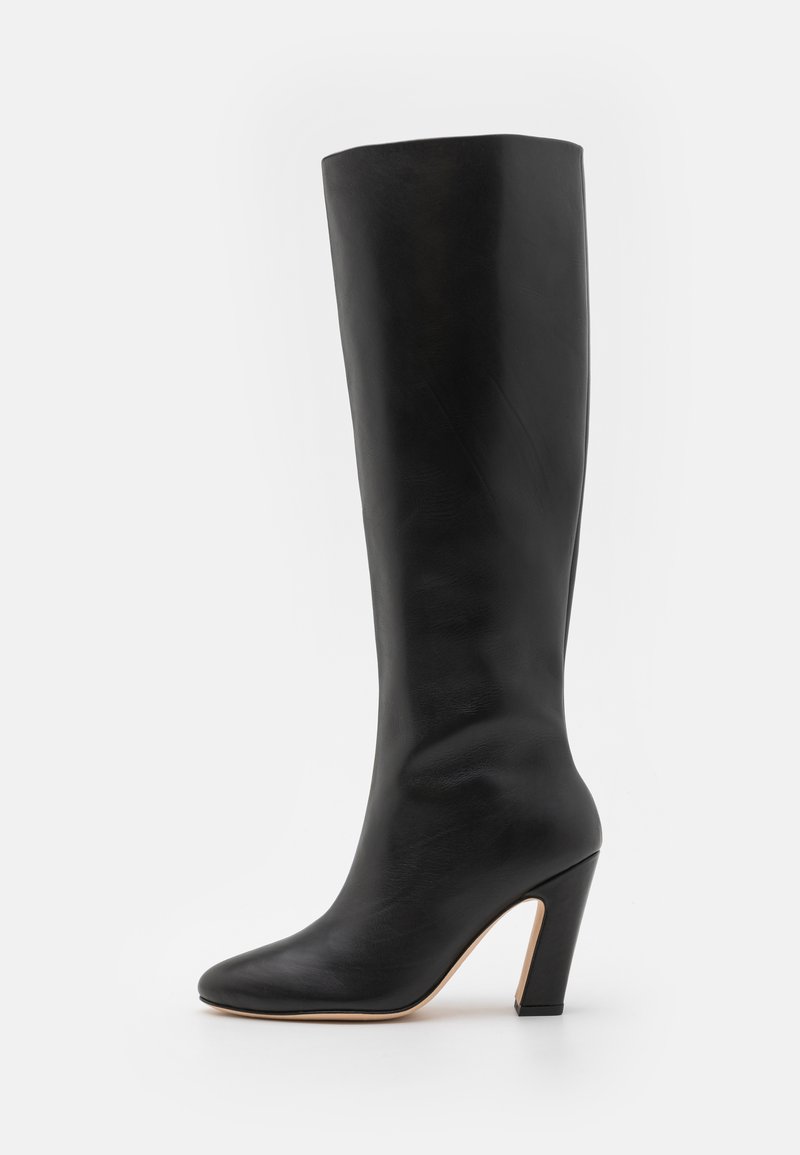 Black knee-high boot made of smooth leather, featuring a pointed toe and a solid block heel for stability.