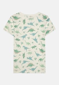 Kortærmet t-shirt i cremefarvet bomuld med grønne dinosaurmotiver, herunder sauropoder og theropoder, afsluttet med en rund halsudskæring og blød tekstur.