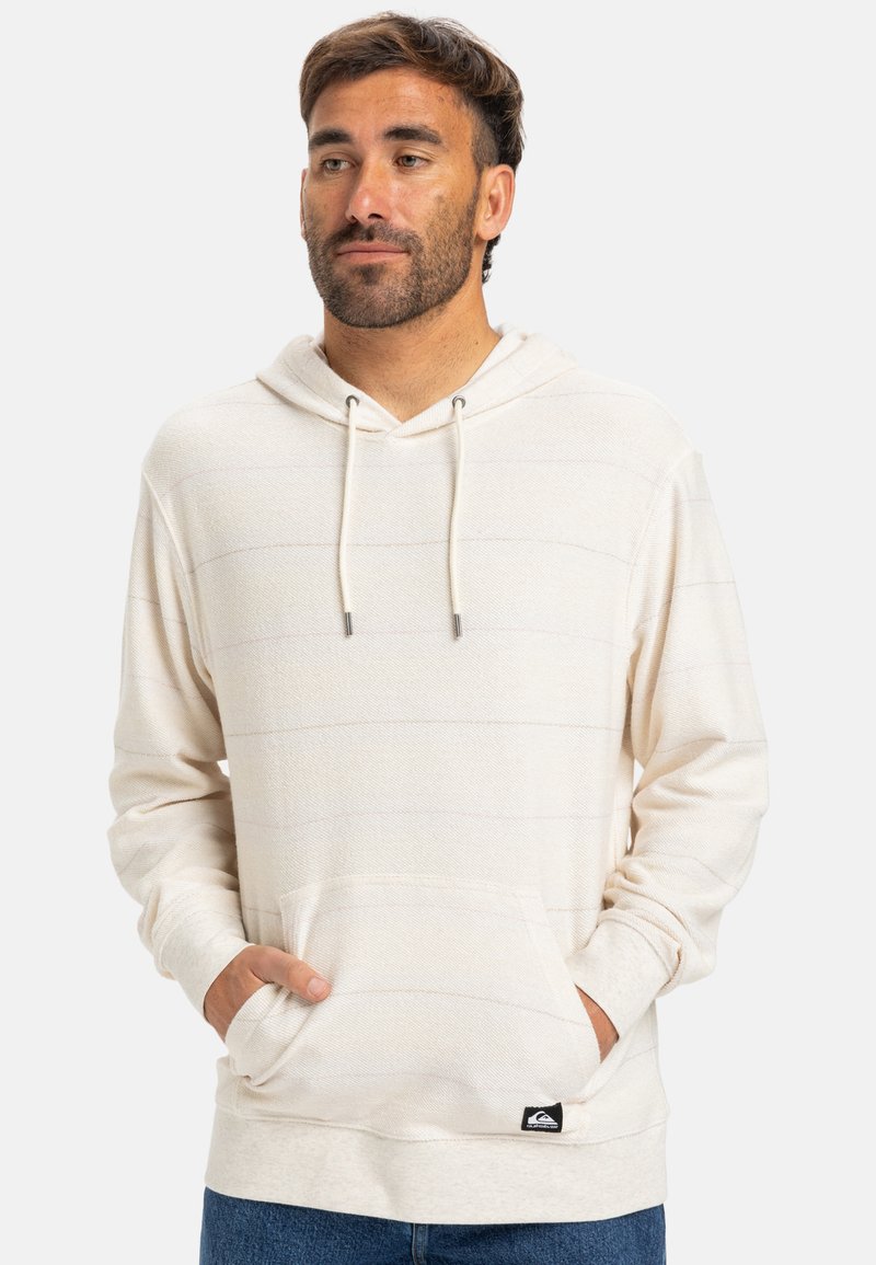 Pullover sweatshirt i lys creme med vandrette striber, frontlomme, justerbar snor og mærkat på den nederste søm.