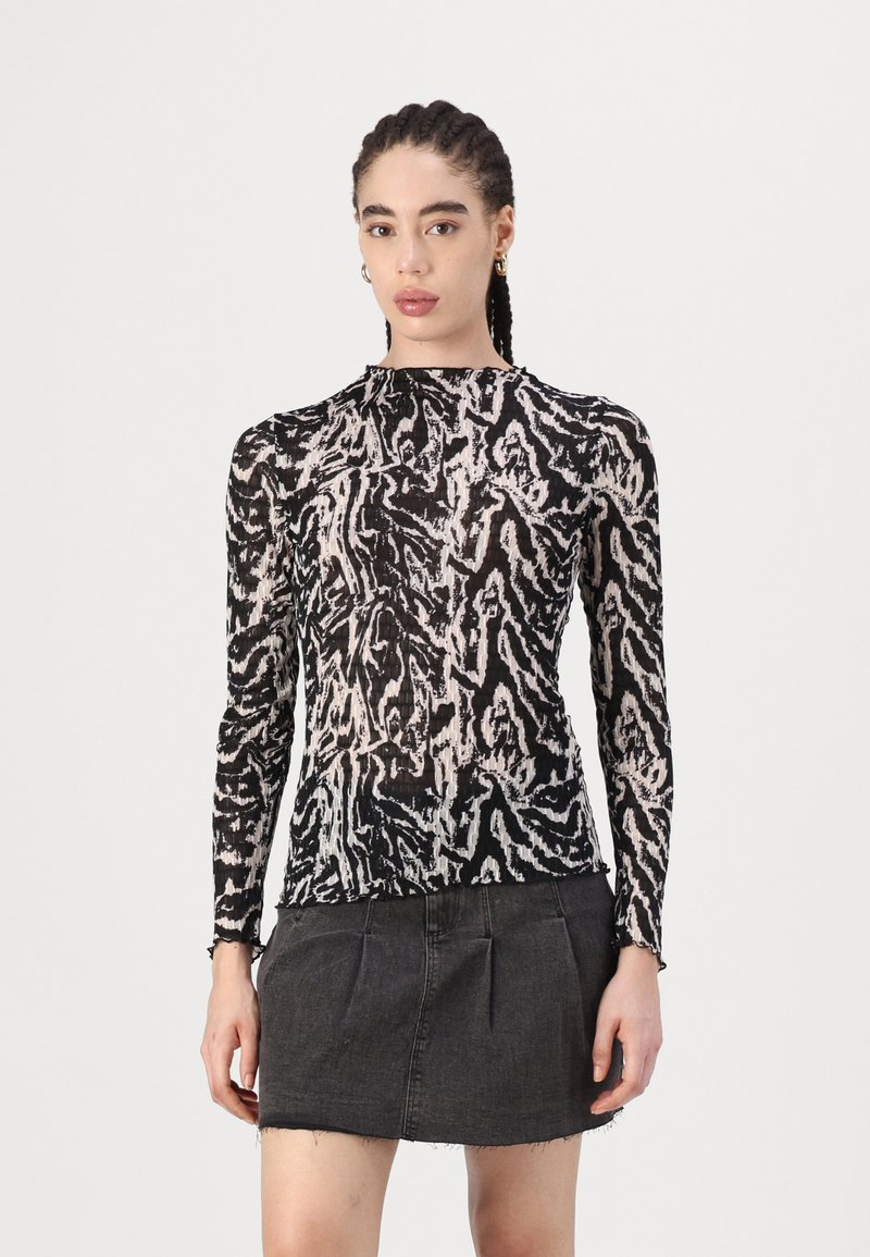 Long-sleeve black and cream sheer top with an abstract animal print design, featuring a high neckline and a structured fit.