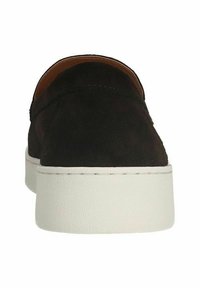 Black suede slip-on shoe with a round toe, elevated white platform sole, minimal stitching detail, and smooth interior lining.