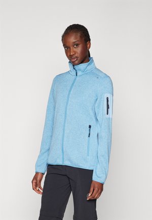 Helleblaue Zip-Jacke aus strukturiertem Stoff, mit hohem Kragen, seitlichen Taschen und einer mit Reißverschluss versehenen Taschen am Ärmel.