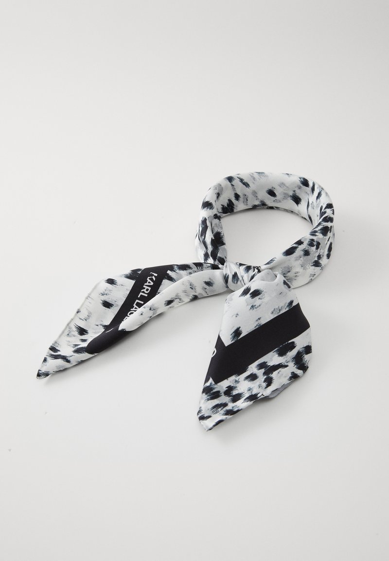 Silk scarf in black, white, and gray. Features spotted pattern and a diagonal black stripe with white text. Twisted knot design.