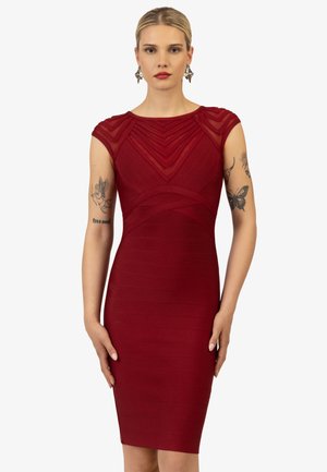 Czerwona sukienka bodycon z krótkimi rękawami, teksturowanym wzorem w paski oraz przezroczystymi wstawkami w okolicach dekoltu i ramion. Długość do połowy łydki.