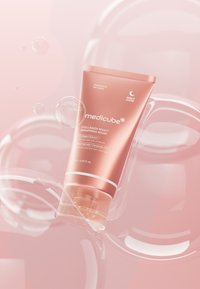Różowo-złota tubka maseczki na noc Medicube Collagen Night Wrapping Mask, z białymi akcentami i przezroczystą podstawą, na miękkim różowym tle z bąbelkami.