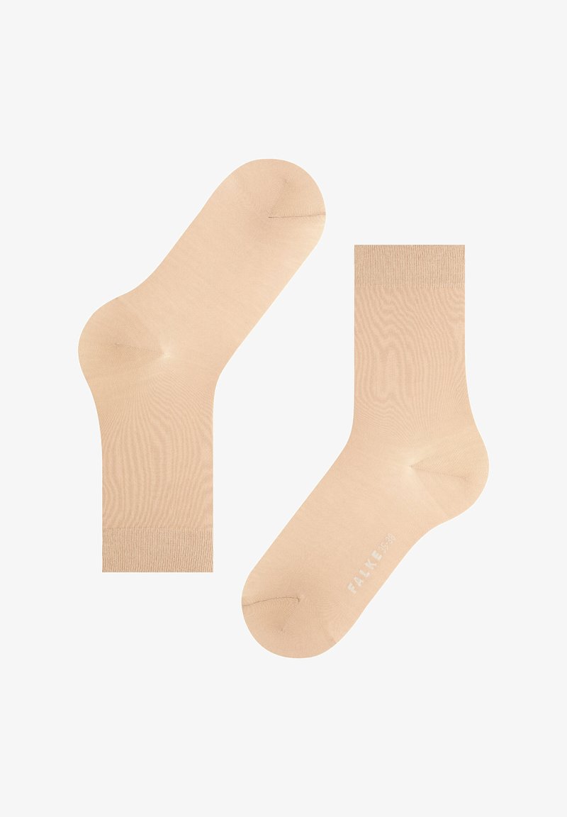 Beige ankle socks made of soft fabric with a smooth texture, featuring reinforced heel and toe sections. Brand name "FALKE" printed.
