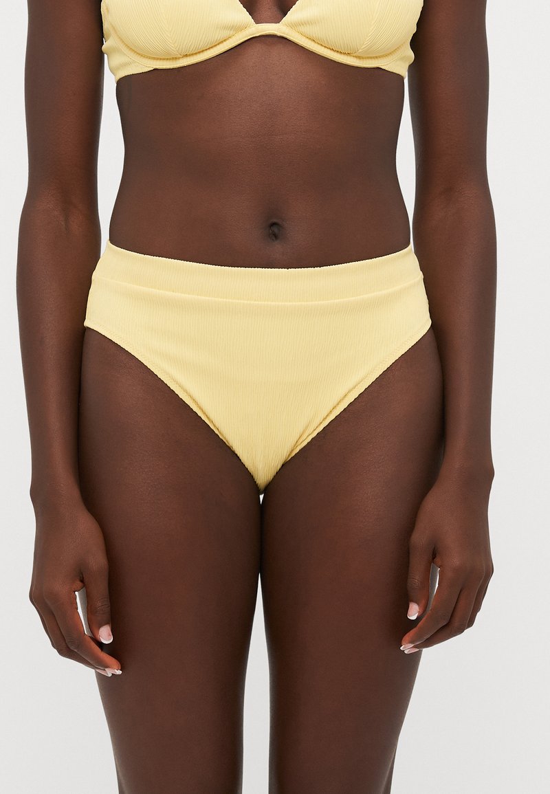 Yellow ribbed bikini top with underwire and matching high-waisted bikini bottoms. The fabric has a textured surface and subtle sheen.