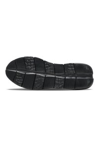 Black rubber shoe sole with textured tread, featuring deep grooves and varied patterns for traction. Flat design with segmented sections.