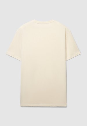 T-shirt color crema a maniche corte con vestibilità rilassata, realizzata in morbido cotone. Presenta scollo rotondo e spalle senza cuciture.