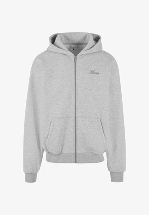 Szara bluza z kapturem zapinana na zamek, wykonana z miękkiego materiału, z podszytym kapturem, dwiema przednimi kieszeniami, ściągaczami przy rękawach i u dołu oraz małym logo na piersi.