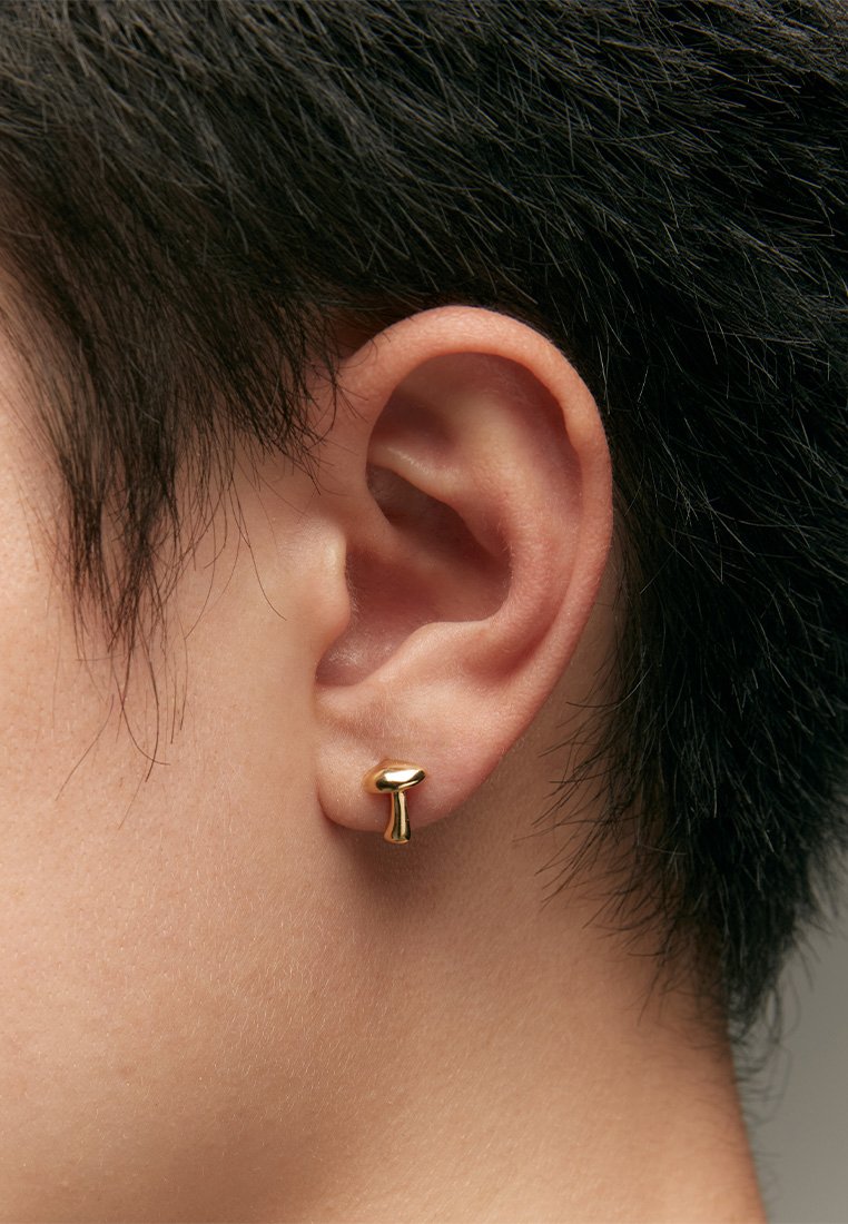 Gold mushroom-shaped earring made of metal, featuring a smooth, reflective surface and a minimalist design, worn on the earlobe.