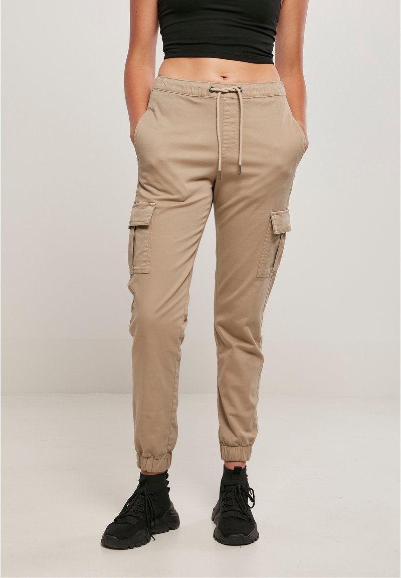 Pantalon cargo kaki avec taille à cordon, poignets élastiques et poches latérales. Confectionné en tissu lisse, arborant une coupe décontractée et un style utilitaire.