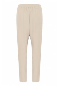 Beige, avsmalnande byxor med elastisk midja, tillverkade av ett glatt tyg. Har en enkel design utan synliga knäppningar eller mönster.