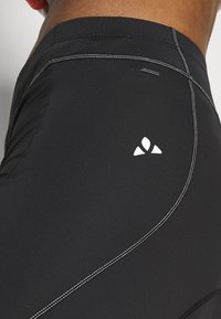 Black athletic shorts with a smooth texture, featuring white accent stitching and a small white logo on the side.