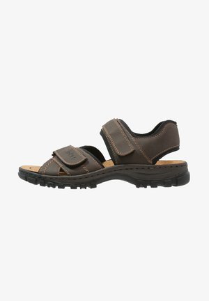 Brown leather sandals with two adjustable Velcro straps, textured rubber sole, and contrast stitching. Open design for breathability.