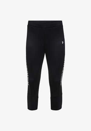 Leggings sportivi neri a vita alta con logo bianco sulla coscia sinistra e testo verticale bianco lungo i lati esterni di entrambe le gambe.
