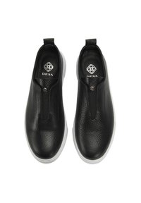 Schwarze Slipper aus strukturiertem Lederobermaterial, mit elastischen Seiteneinsätzen und weißer Gummisohle. Minimalistisches Design mit markiertem Innensohlen-Detail.